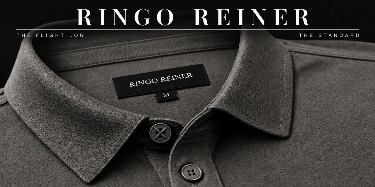 Close-up of the Neutral Grey Founder Polo showing its structured collar, Ringo Reiner label, signature four-blade top button and tonal standard placket button.