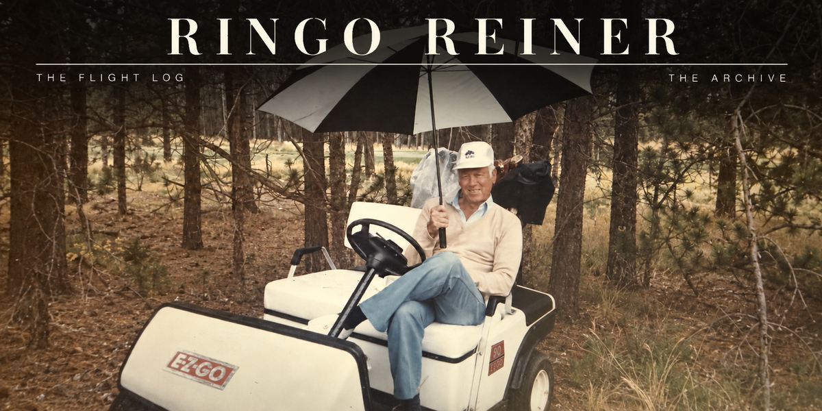 Richard “Ringo” Reiner smiling beneath an umbrella while seated in a golf cart at Oak Hills Country Club.