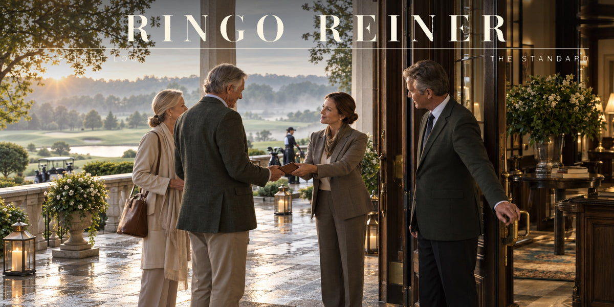 Club leaders welcoming a well-dressed couple at the entrance of a private golf club overlooking the course.