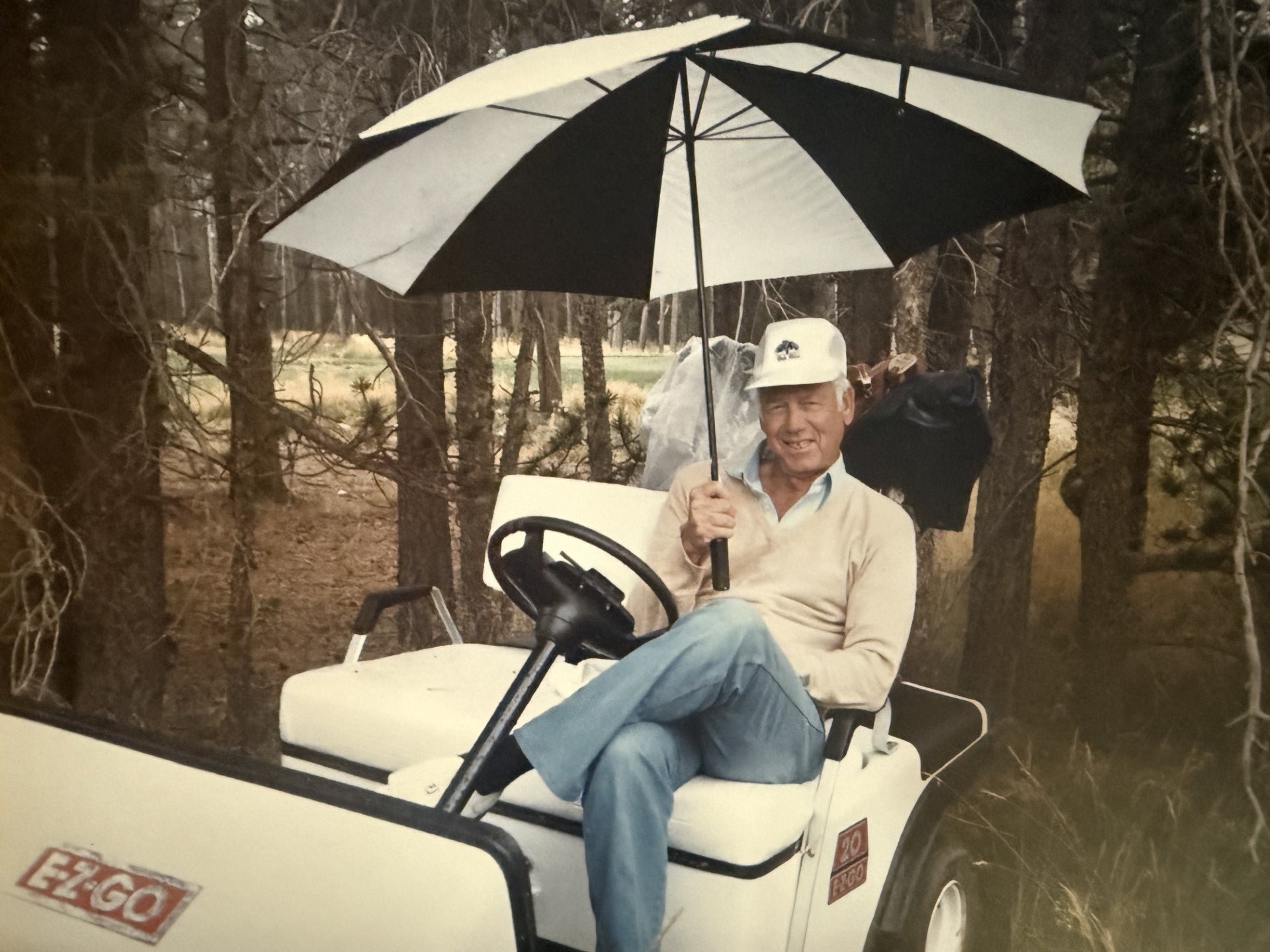 Ringo Reiner sitting in EZGO golf cart at Oak Hills CC